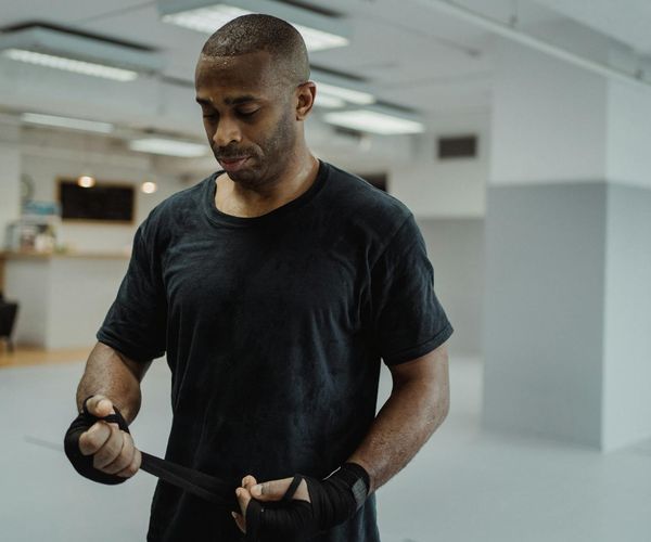A man focused during a workout session with a calm expression.